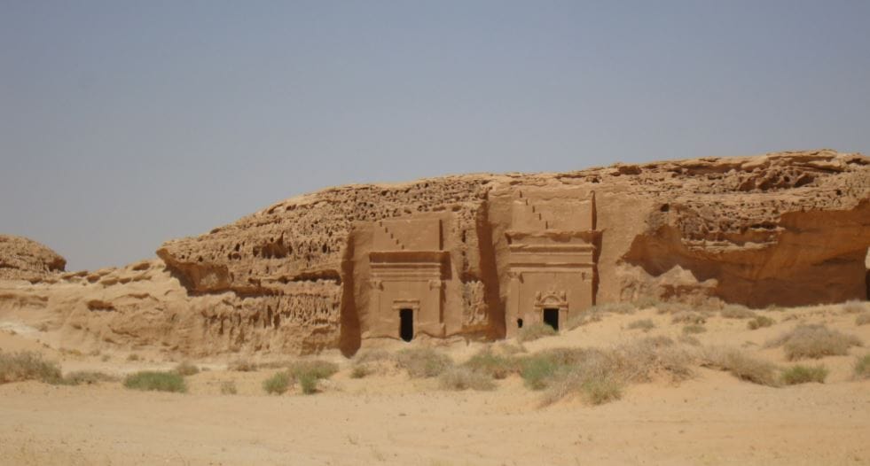 a desert scene with a building in the middle of the desert